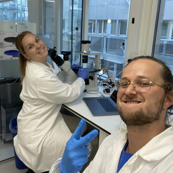 Thor and a CellCount.ai colleague in lab coats at a microscope